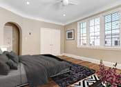 Thumbnail 3 of 8 - a bedroom with a bed and a ceiling fan