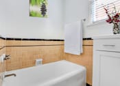 Thumbnail 8 of 8 - a bathroom with a white tub and a sink