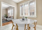 Thumbnail 5 of 8 - a dining room with a white table and chairs