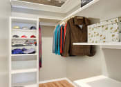 Thumbnail 3 of 17 - Spacious walk-in closet with wood-style floors