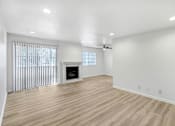 Thumbnail 4 of 18 - a living room with white walls and a fireplace