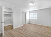 Thumbnail 7 of 18 - an empty living room with a closet and a window