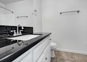 Thumbnail 9 of 18 - a bathroom with a sink and a toilet