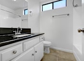 Thumbnail 8 of 18 - a white bathroom with a sink and a toilet