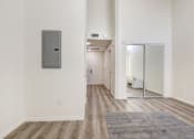 Thumbnail 41 of 42 - Living and sleeping area with mirrored closet doors, laminate flooring