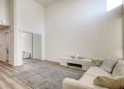 Thumbnail 30 of 42 - Living and sleeping area with wood style flooring throughout, mirrored closet doors, brightly lit