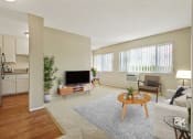 Thumbnail 10 of 22 - Living room with carpeted floors and Kitchen area with wood inspired floors