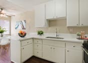 Thumbnail 5 of 22 - Kitchen With a single sink, small breakfast bar, stainless steel refrigerator