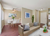 Thumbnail 4 of 22 - Living room and dining area with wood-style floors throughout