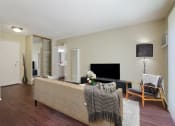 Thumbnail 2 of 22 - Wood-inspired floors in living room with a mirrored closet doors