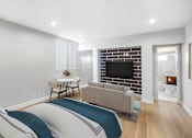 Thumbnail 10 of 49 - a bedroom with a bed and a couch and a tv