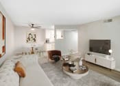 Thumbnail 8 of 15 - a living room with a white couch and a tv