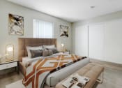 Thumbnail 9 of 15 - a bedroom with a bed and a large window