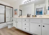 Thumbnail 10 of 15 - a white bathroom with a toilet and a large mirror