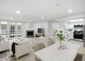 Thumbnail 1 of 25 - a living room and dining room with white furniture and a table