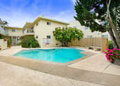 Thumbnail 9 of 9 - a swimming pool in front of a house with a pool