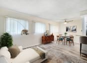 Thumbnail 4 of 9 - a living room and dining room with a couch and a table