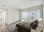 Thumbnail 6 of 9 - a bedroom with a bed and a sliding glass door