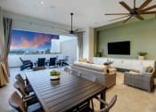 Thumbnail 2 of 26 - a large living room with a wooden table and chairs