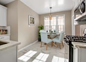 Thumbnail 3 of 7 - an open kitchen and dining room with a table and chairs