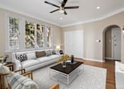 Thumbnail 2 of 7 - a living room with a couch and a coffee table