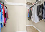 Thumbnail 7 of 7 - a closet with a rack of clothes and a door to a closet