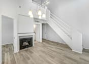 Thumbnail 16 of 62 - an empty living room with a fireplace and stairs