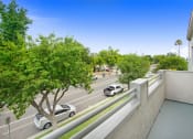 Thumbnail 17 of 62 - a view of a parking lot from a balcony with cars on the street