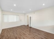 Thumbnail 62 of 63 - an empty living room with white walls and wood flooring