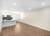 Thumbnail 52 of 63 - the living room and kitchen of an apartment with wood flooring