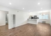 Thumbnail 15 of 63 - the living room and kitchen of a new home with white walls and wood flooring