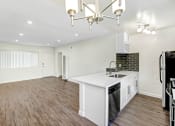 Thumbnail 30 of 63 - an open kitchen and living room with a white counter top