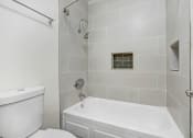 Thumbnail 18 of 63 - a white bathroom with a shower and a toilet