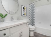 Thumbnail 12 of 95 - a bathroom with a sink and a toilet and a bath tub