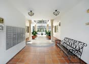Thumbnail 82 of 88 - the lobby of a building with a bench and a door
