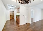 Thumbnail 35 of 88 - a dining room and kitchen with white walls and a large chandelier