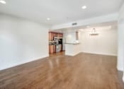 Thumbnail 32 of 88 - an empty living room and kitchen with wood flooring and a chandelier