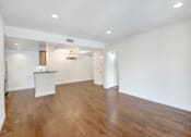 Thumbnail 34 of 88 - an empty living room with white walls and wood flooring