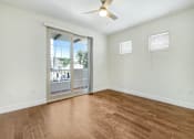 Thumbnail 39 of 88 - an empty living room with a sliding glass door to a balcony