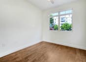 Thumbnail 42 of 88 - an empty living room with a window and wooden floors
