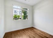 Thumbnail 41 of 88 - an empty room with a window and wooden floors