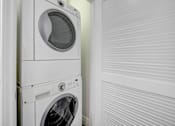 Thumbnail 36 of 88 - a white washer and dryer in a laundry room next to a white door