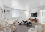Thumbnail 8 of 14 - a living room with a couch and a tv
