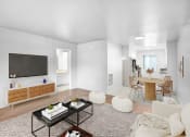 Thumbnail 7 of 14 - a living room with a television and a table with chairs