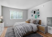 Thumbnail 9 of 14 - a bedroom with a bed and a rug