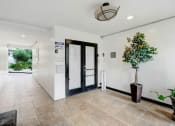 Thumbnail 14 of 14 - a lobby with a plant and a glass door