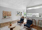 Thumbnail 40 of 65 - a living room with chairs and a bar and a kitchen