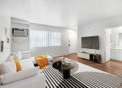Thumbnail 3 of 14 - a living room with a white couch and a zebra rug