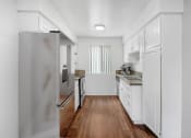 Thumbnail 1 of 14 - a renovated kitchen with white cabinets and stainless steel appliances