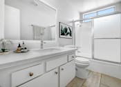 Thumbnail 46 of 65 - a bathroom with a sink toilet and a shower